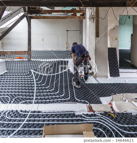 Pipe fitter mounting underfloor heating. Pipe fitter mounting underfloor heating. 34646621