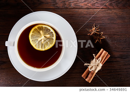 White porcelain cup of tea with cinnamon sticks 34649891