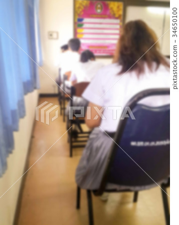 Blur students doing exam in classroom Blur students doing exam in classroom 34650100