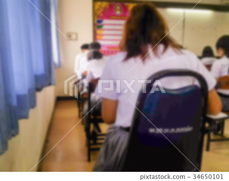 Blur students doing exam in classroom Blur students doing exam in classroom 34650101