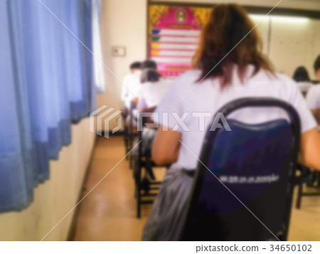 Blur students doing exam in classroom Blur students doing exam in classroom 34650102