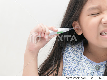 asian kid girl cleans her ear with ear pick, 34651673
