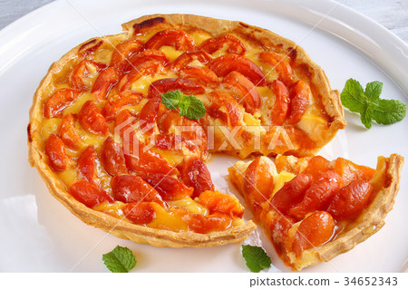 homemade apricot tart on white platter 34652343