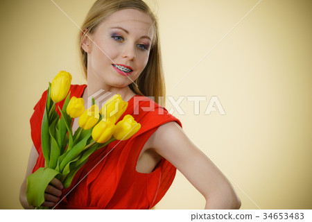 Pretty woman with yellow tulips bunch Pretty woman with yellow tulips bunch 34653483