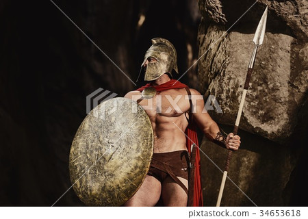 Powerful gladiator posing on rocks  34653618