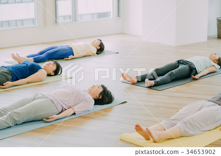 Young woman doing yoga in studio 34653902