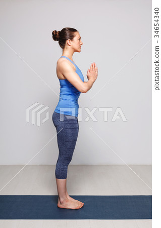 Woman doing Hatha Yoga asana Tadasana  34654340
