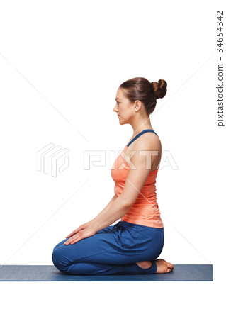 Woman in Hatha yoga asana Vajrasana 34654342