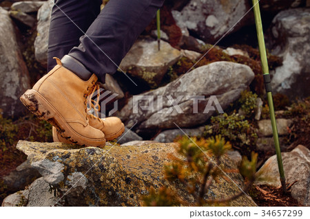 hiking boots on the rock in the mountains. 34657299