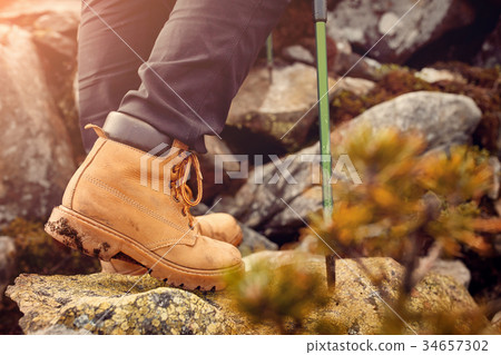 hiking boots on the rock in the mountains. 34657302