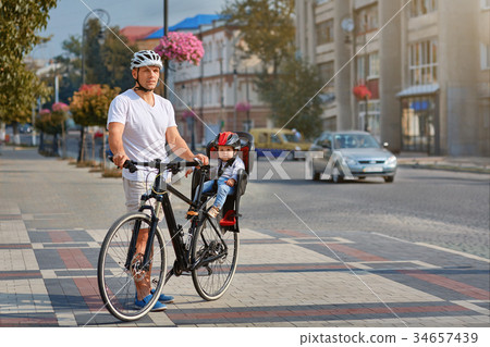 Cheerful family biking in park Cheerful family biking in park 34657439