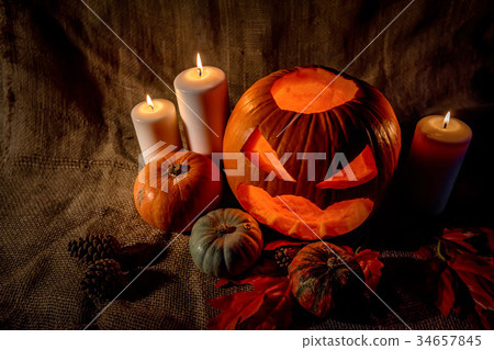 Halloween pumpkin head with burning candles Halloween pumpkin head with burning candles 34657845