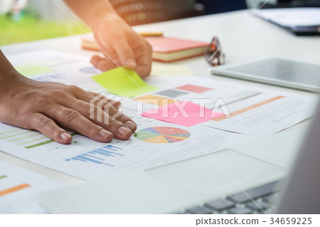 Office worker analyzing graph. Office worker analyzing graph. 34659225
