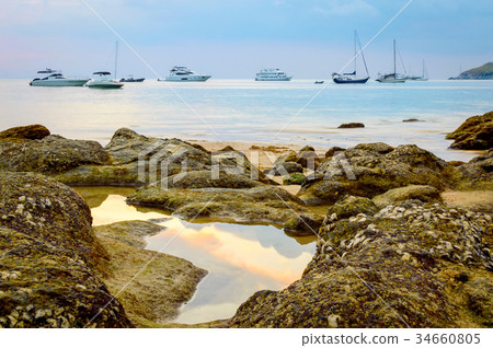 Beautiful gold sundown at rocky coast Beautiful gold sundown at rocky coast 34660805