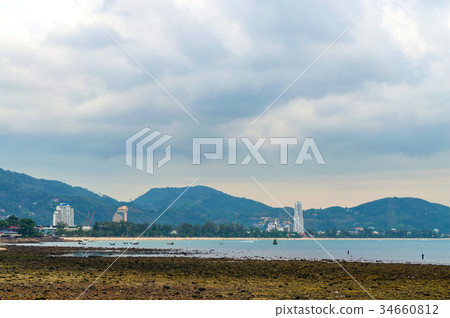 View of rocks on sandy beach in low tide 34660812