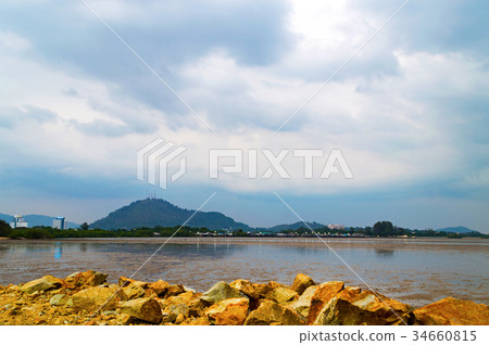 View of rocks on sandy beach in low tide View of rocks on sandy beach in low tide 34660815
