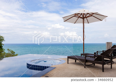 Beach chair in outdoor with Swimming pool Beach chair in outdoor with Swimming pool 34660952