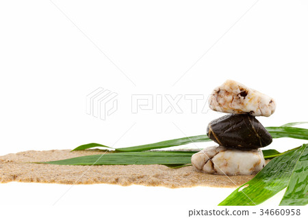stack of stone and bamboo leaves on sand stack of stone and bamboo leaves on sand 34660958