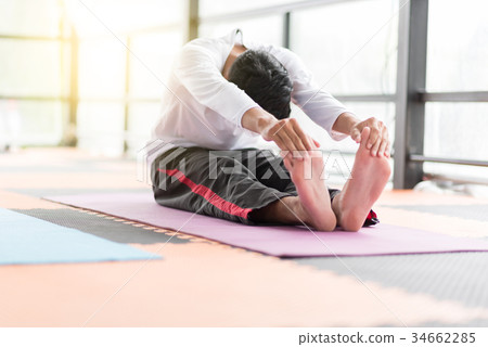 Group of  people doing yoga in the class 34662285