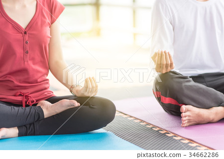 Group of  people doing yoga in the class 34662286