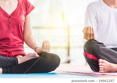 Group of  people doing yoga in the class 34662287