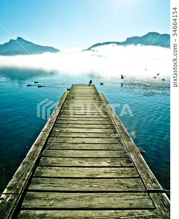 Pier by mountain lake Mondsee in Austria Pier by mountain lake Mondsee in Austria 34664154