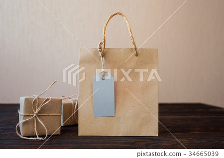 Mockup Paper bag from kraft paper with gift tag Mockup Paper bag from kraft paper with gift tag 34665039
