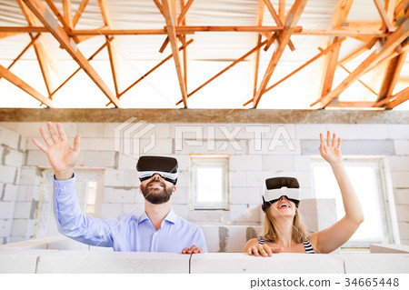 Young married couple at the construction site. 34665448