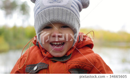 Child in autumn Park having fun playing and Child in autumn Park having fun playing and 34665605