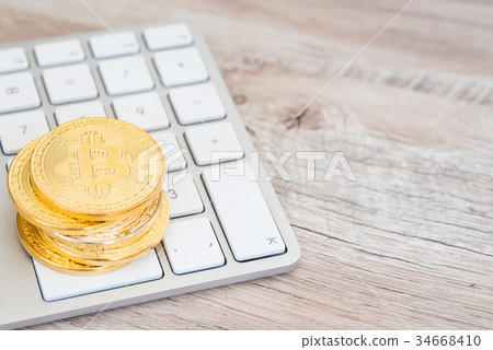 Golden bitcoin on a keyboard Golden bitcoin on a keyboard 34668410