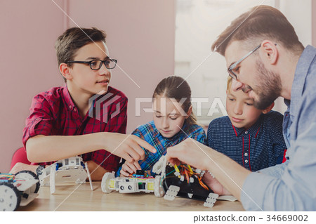Stem education. Kids creating robots with teacher Stem education. Kids creating robots with teacher 34669002