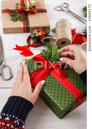 Gift wrapping. Wrapping modern christmas present 34669170