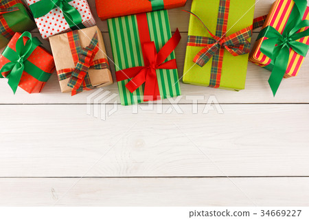 Christmas gift boxes, top view on wood table Christmas gift boxes, top view on wood table 34669227