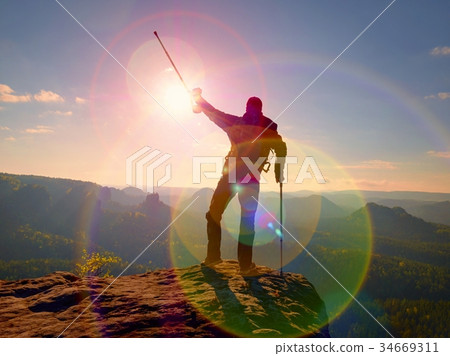 Sharp rear man silhouette on peak. Satisfy hiker 34669311