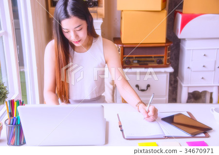 A young business woman using laptop computer. A young business woman using laptop computer. 34670971