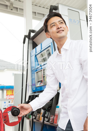 Gas station refueling self person drive car rental Gas station refueling self person drive car rental 34673004
