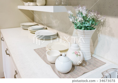 Modern kitchen with decoration and kitchenware  34673078