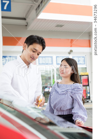 Gas station refueling self person drive car rental 34673296