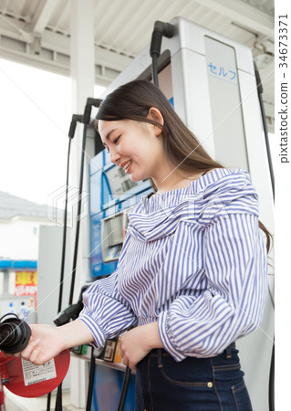 Gas station refueling self person drive car rental 34673371