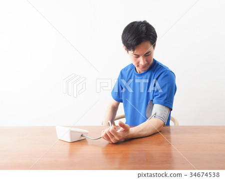 Men measuring blood pressure 34674538