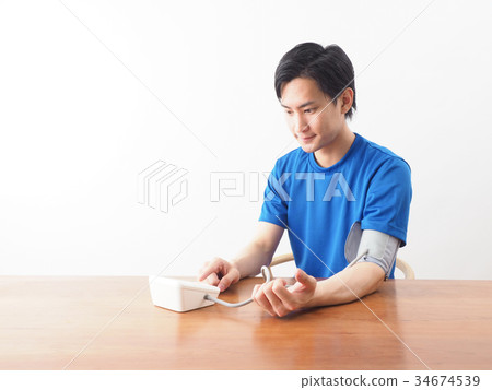 Men measuring blood pressure Men measuring blood pressure 34674539