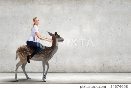Woman ride deer 34674698