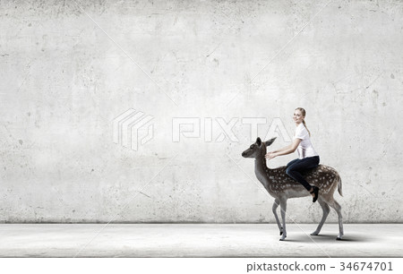 Woman ride deer 34674701