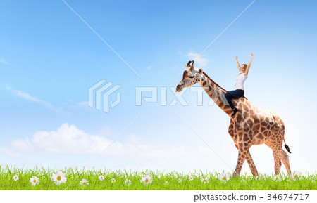 Woman ride giraffe 34674717