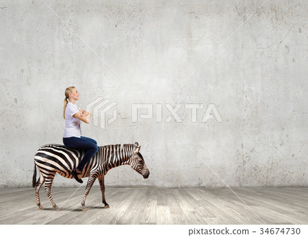 Woman ride zebra 34674730