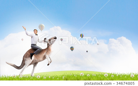 Woman ride kangaroo 34674805