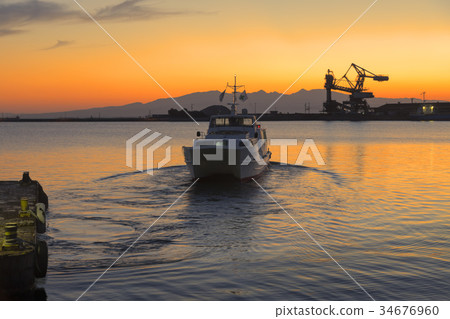 High speed boat leaving at dusk High speed boat leaving at dusk 34676960