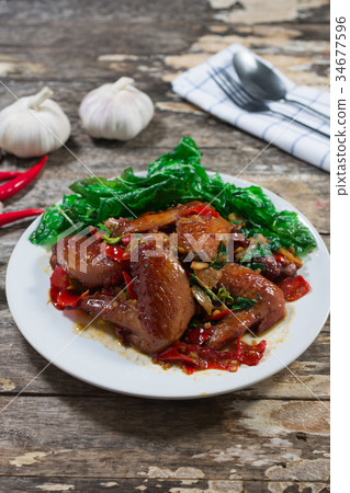 Fried chicken wings with basil sauce 34677596