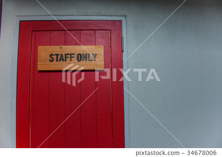 the red door with wood staff only sign on it. the red door with wood staff only sign on it. 34678006
