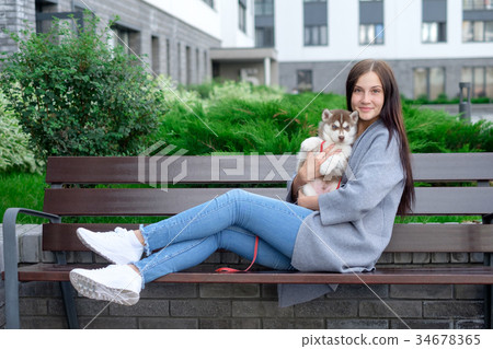 Beautiful young woman sitting on wooden bench and Beautiful young woman sitting on wooden bench and 34678365